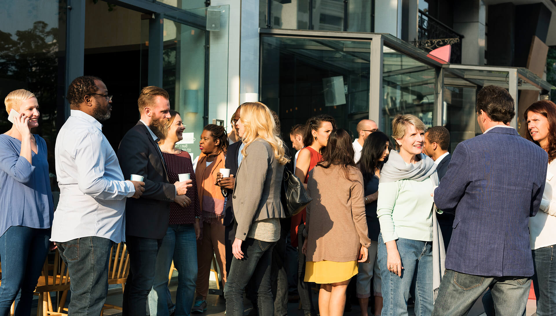 Group of people standing outside and talking to each other