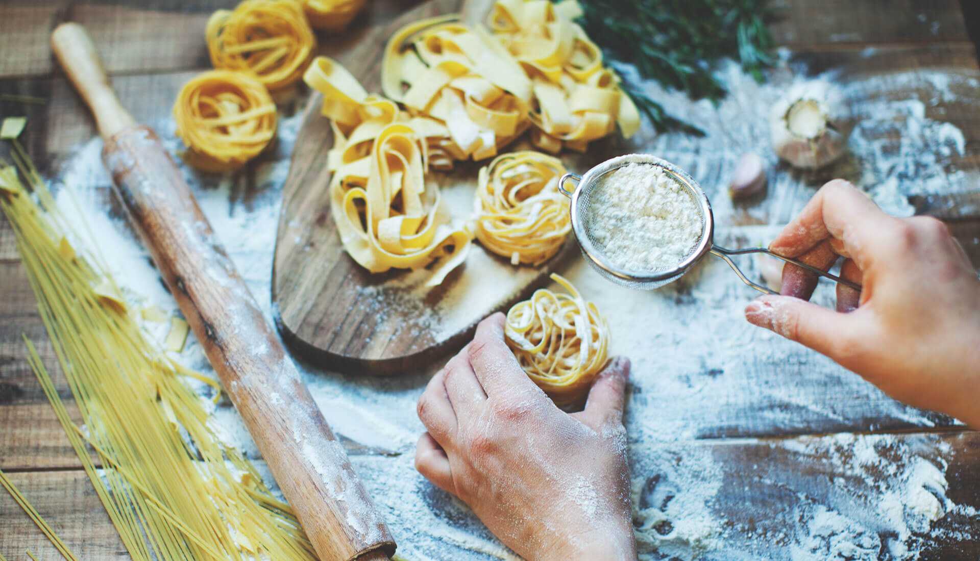 Pasta being prepared on a bread board