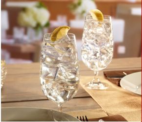 Two glasses of ice with water and lemon wedge