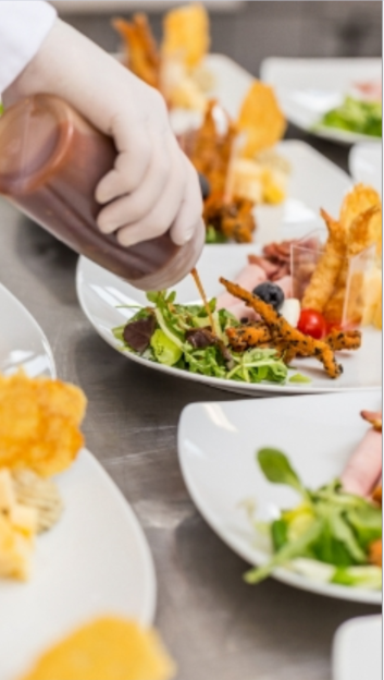 Sauce being drizzled on a salad