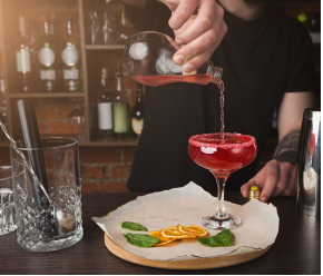 Bartender pouring a drink into a glass