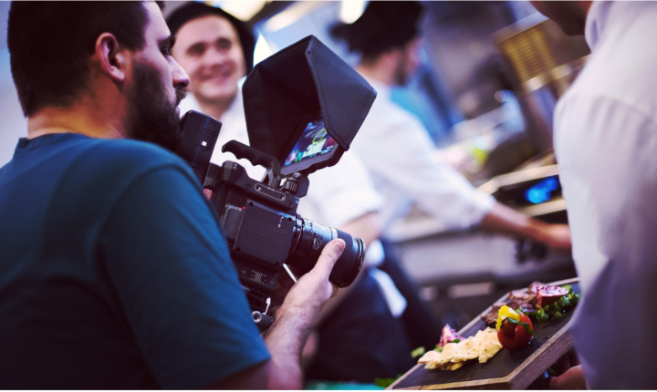 Man filming food being prepared on a counter