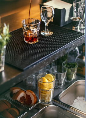 A glass on a countertop with a liquid being poured into it