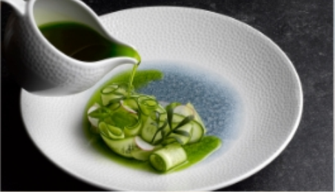 sauce being poured on a display dish